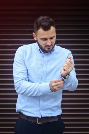 Portrait of a businessman, manager on a striped wall background. A bearded sexy man in a shirt. Stock photosの写真素材