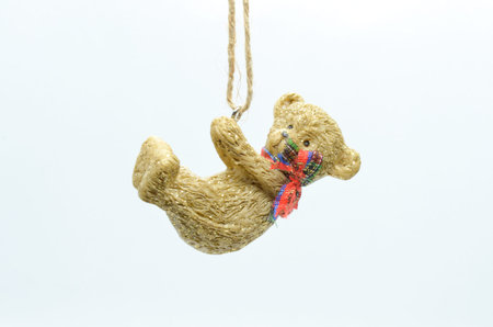 Christmas toy teddy bear with a red scarf on a light backgroundの写真素材