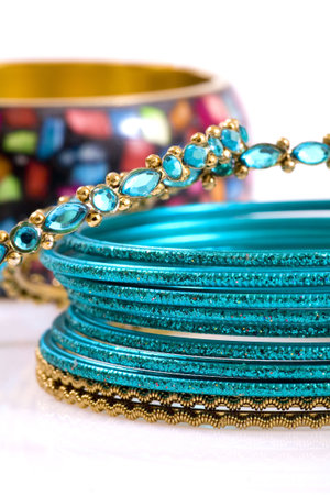 Fashion bracelets on white background, blue and green.