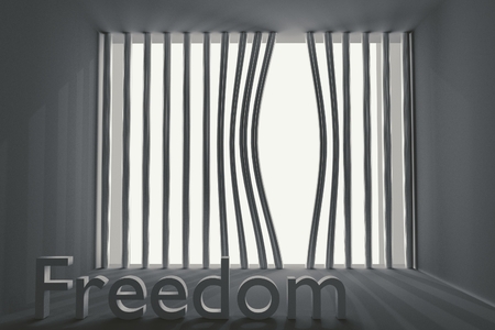bent prison bars and the inscription freedomの写真素材