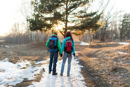 Hiking couple in spring forest. Outdoor adventures concept.