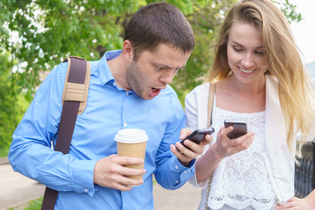 smiling business team with smartphones at outdoorの写真素材