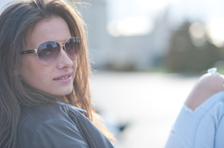 Outdoor portrait of beautiful girl with sunglassesの写真素材