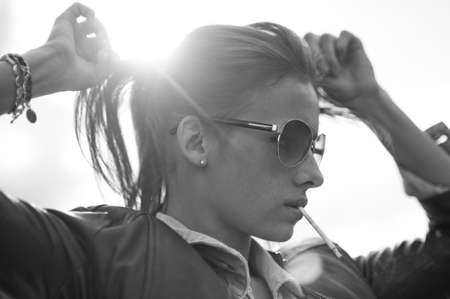 Outdoor portrait with beautiful girl. Black and white toned image.の写真素材