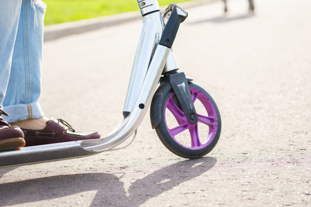 Closeup view with legs on skateboard scooter