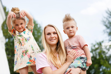 beautiful young girl playing with her childrenの写真素材