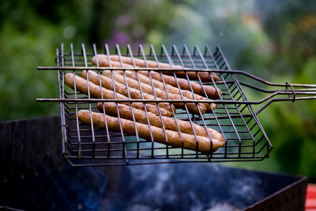 Appetizing sausage on the grill outdoors on summer dayの写真素材