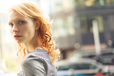 Ginger girl close-up of summer in street, photo tonedの写真素材