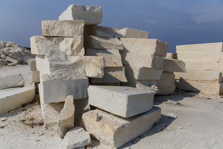 Bunch of stone blocks, historic ruins under blue sky on sunny dayの写真素材