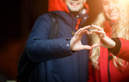 Beautiful couple outdoors in winter holiday in evening