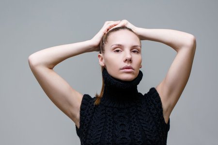 Young girl in studio in black jacket on blank backgroundの写真素材