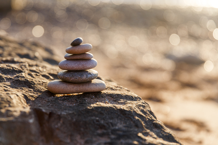 Pyramid of pebbles at seasideの写真素材