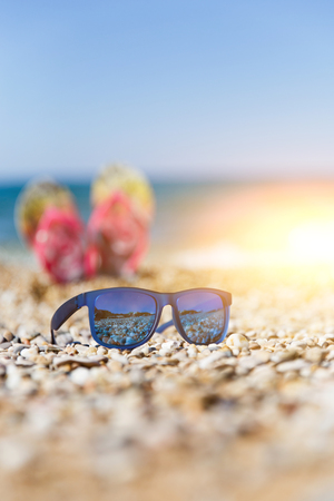 Photo of sunglasses on seashoreの写真素材