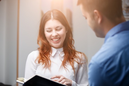 Young girl laughing in officeの写真素材
