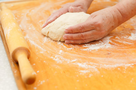 Dough with flour on table