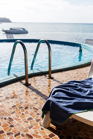 Photo of pool and sun lounger by seaの写真素材