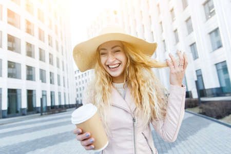 Cheerful young blonde with coffeeの写真素材
