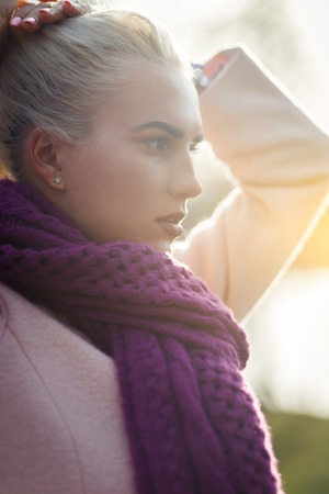 Woman straightens hair in parkの写真素材