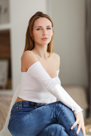 Girl in jeans at roomの写真素材