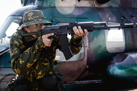 Photo of a soldier with an automatic rifleの写真素材