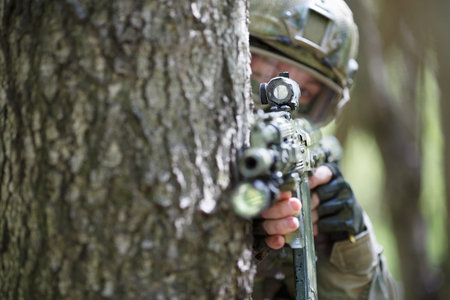 Soldier with rifle in forest