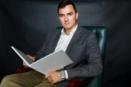 Picture of business brunet in suit and book