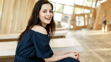 Photo of smiling girl in black dress