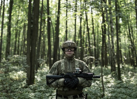 Portrait of military man in helmet and with submachine gunの写真素材