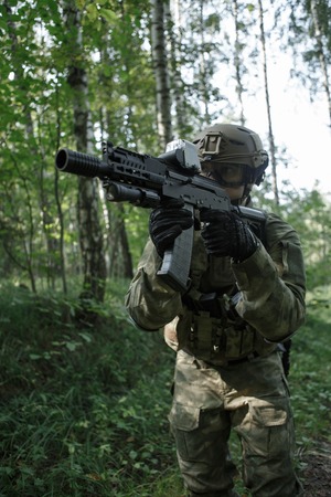 Portrait of soldier in helmet and with submachine gunの写真素材