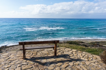 Photo of bench on background of seaの写真素材