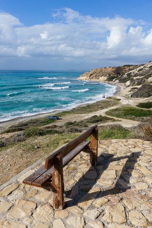 Image of bench, sea bay, hilly slope with vegetationの写真素材