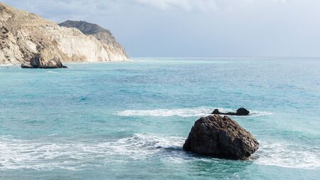 Image of sea, rocks, rocky slope, cloudy skyの写真素材
