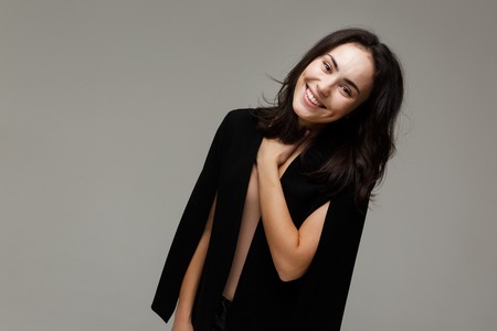 Beautiful fashionable smiles woman in in jeans and a jacketの写真素材