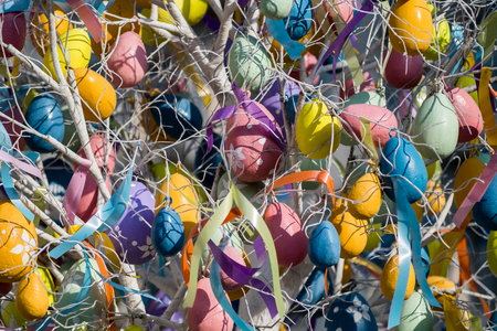 Photo of Easter tree with colorful eggs and ribbonsの写真素材