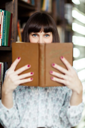 Image of young brunette with book in hand