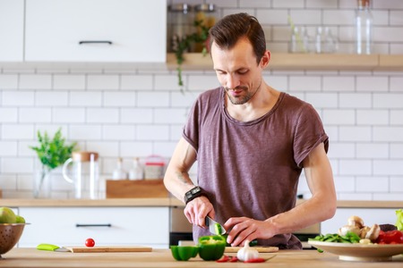 Image of brunet cooking vegetables on tableの写真素材