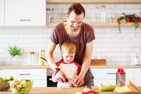 Image of man with son cooking vegetablesの写真素材