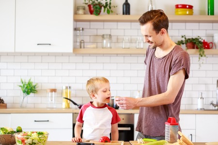 Image of father with son cooking vegetablesの写真素材