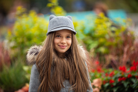 Photo of smiling girl in gray hat and coat