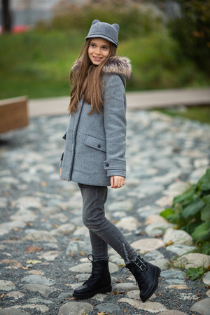 Photo of smiling girl in gray hat and coatの写真素材