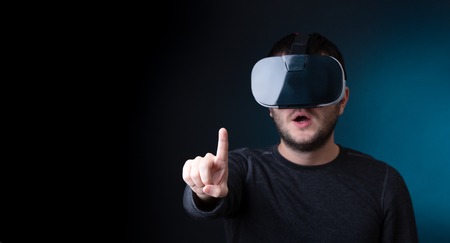 Photo of surprised brunet in virtual reality glassesの写真素材