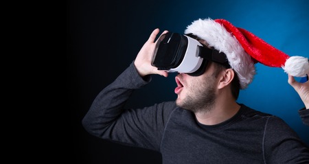 Image of man in Santas cap and glasses of virtual realityの写真素材