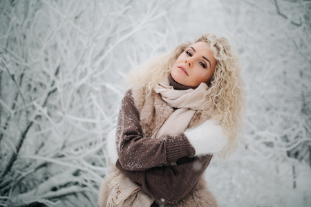 Photo of woman on walk in winter forestの写真素材