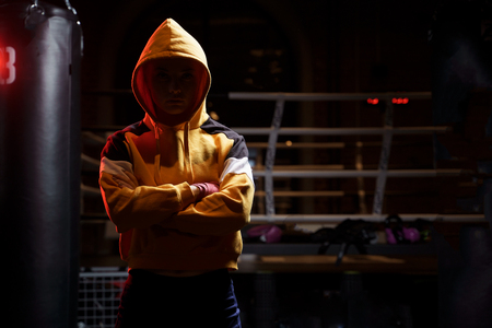 Sports woman boxer pulls red bandages around her hands on ring.の写真素材