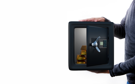 Man holds an open safe with coins .の写真素材