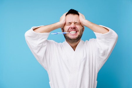 Photo of man with toothbrush in his mouth isolatedの写真素材