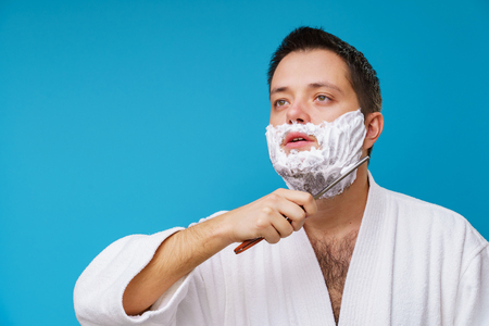 Photo of male in white coat shavingの写真素材