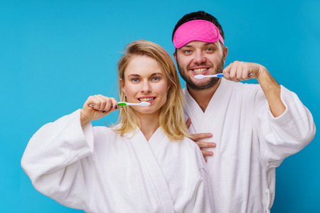 Photo of woman and man with blindfold and toothbrushes in handsの写真素材