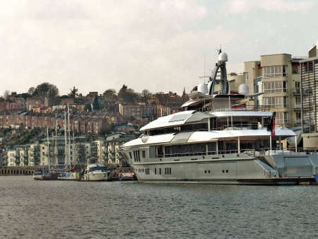 A Super Yacht berthed at Bristol docks with Clifton Wood and Hotwells in the background  のeditorial素材