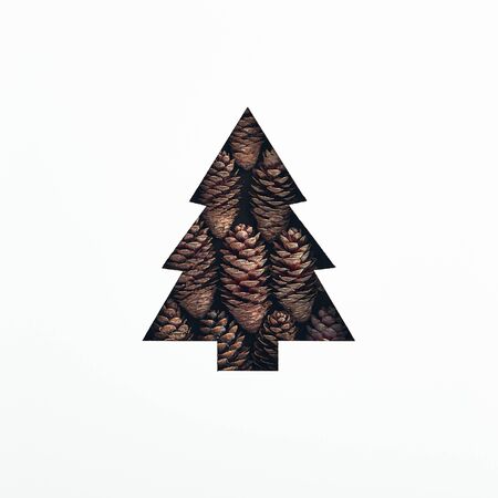 Christmas minimal concept - creative christmas tree made from pine cones. Merry christmas card. Festive decoration element. Minimal flatlay. Rustic tree flat cone for decorative design.の写真素材